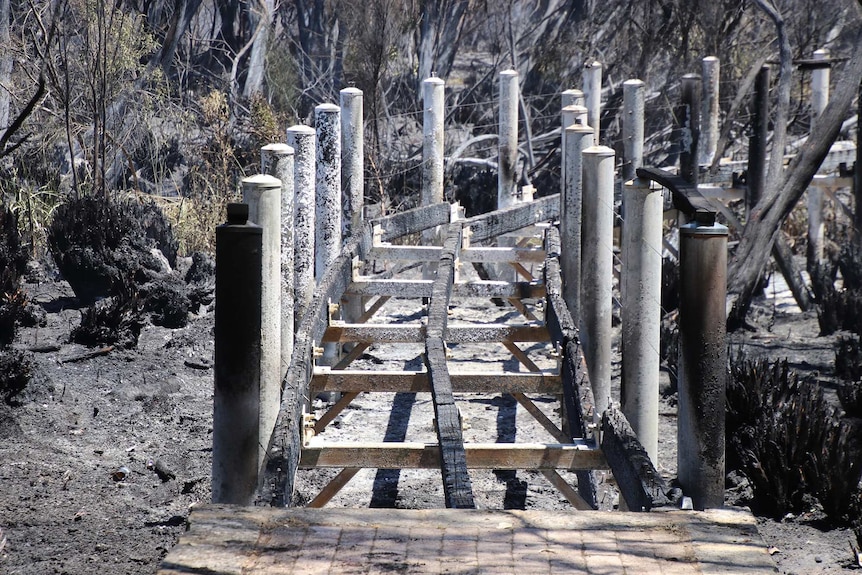 A close-up shot of a burnt-out wooden walkway in Yanchep National Park after a bushfire tore through the area.
