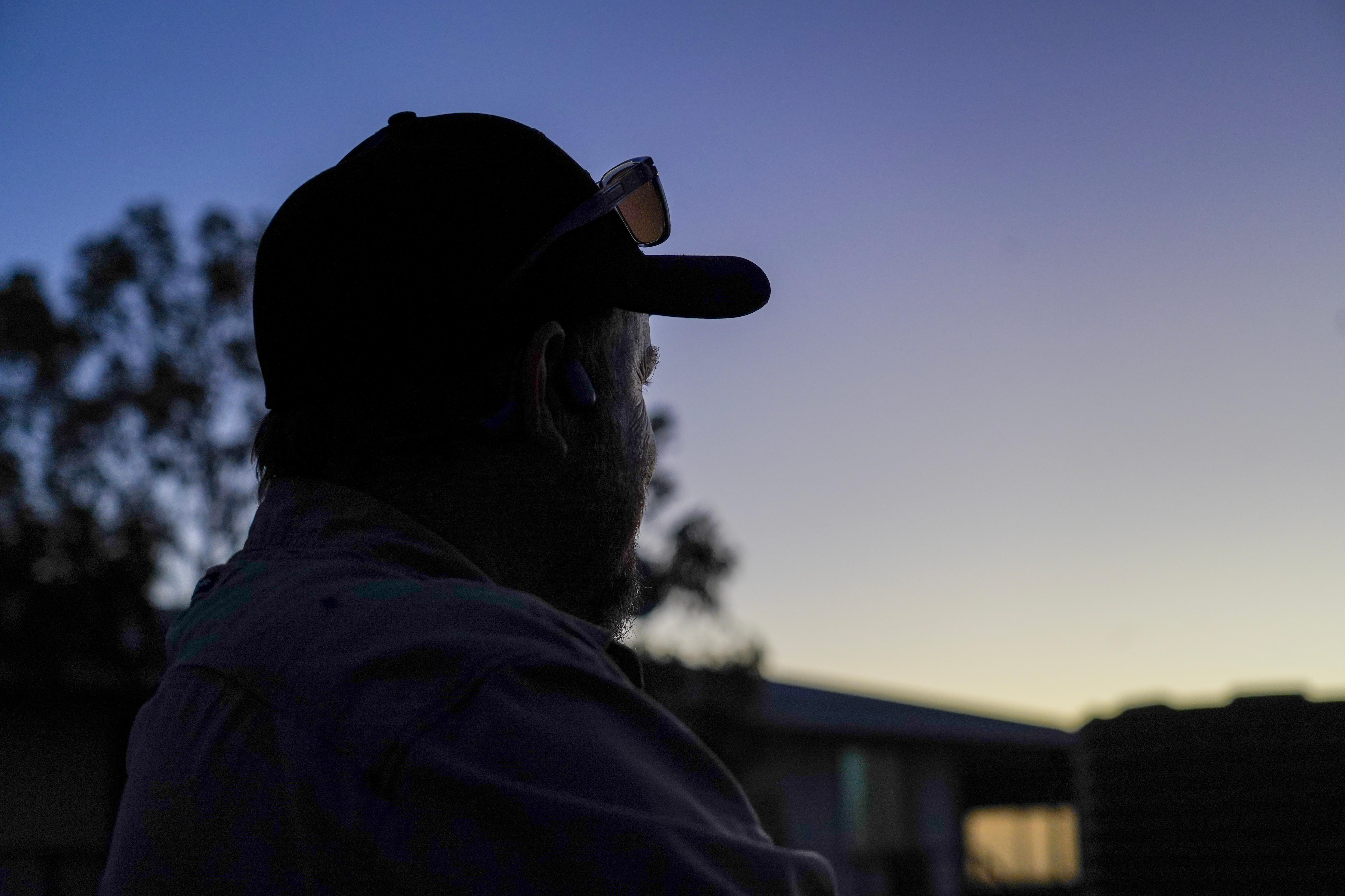 Man watching sunset with purple sky