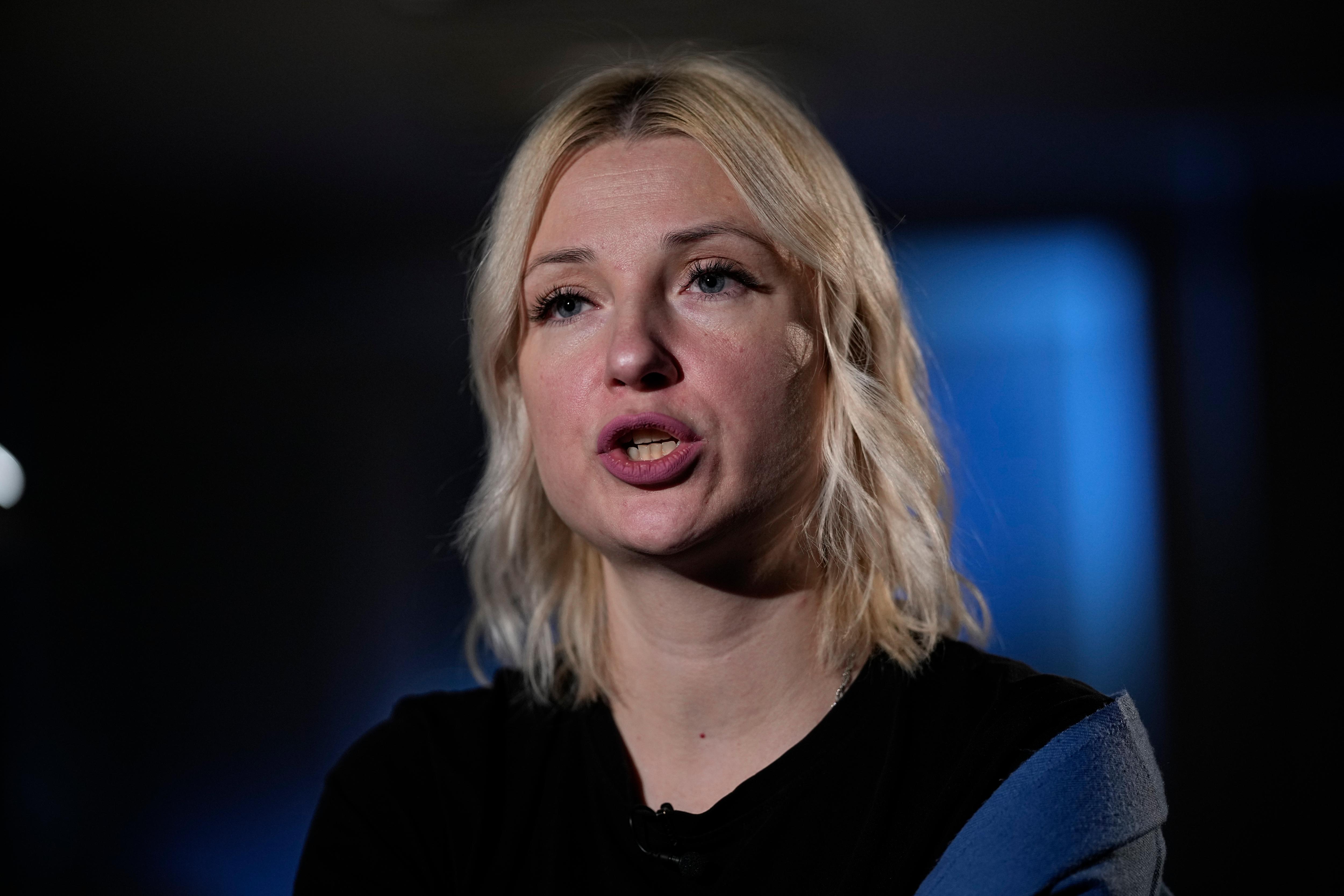 woman with blonde hair speaks to camera