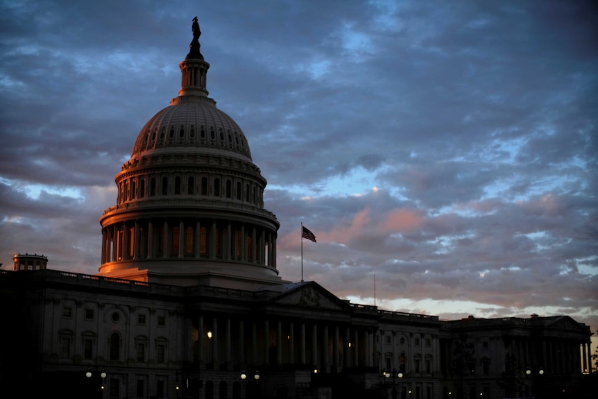 The sun sets behind the U.S. Capitol dome in Washington, U.S
