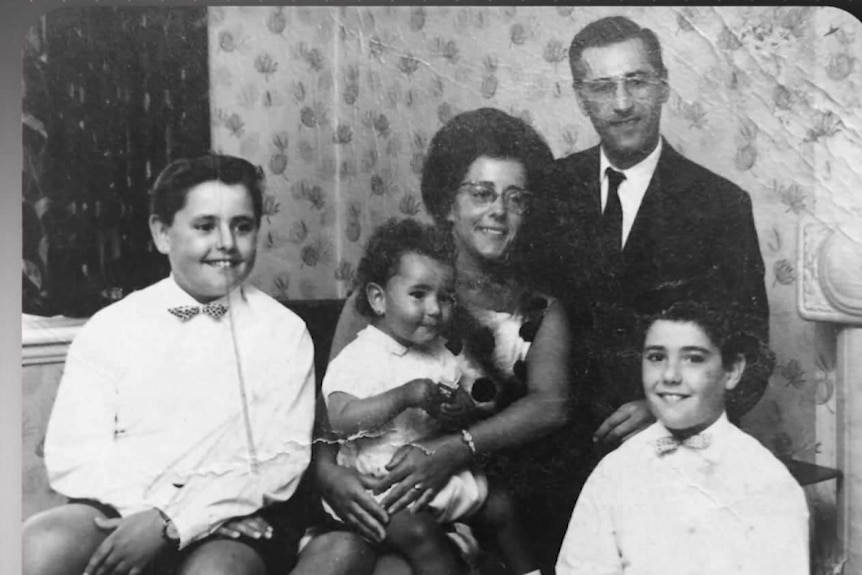 Black and white photo of two parents and three children.