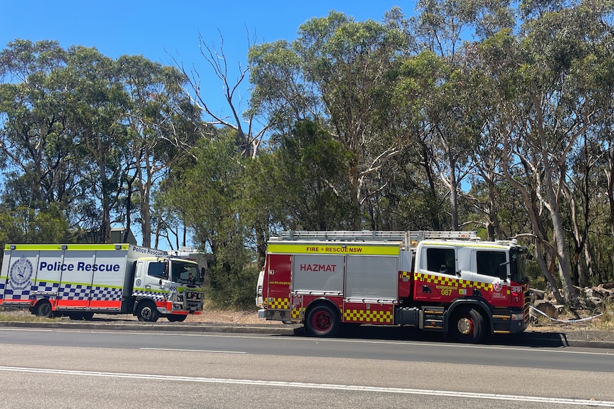 Emergency vehicles on a road in the bush