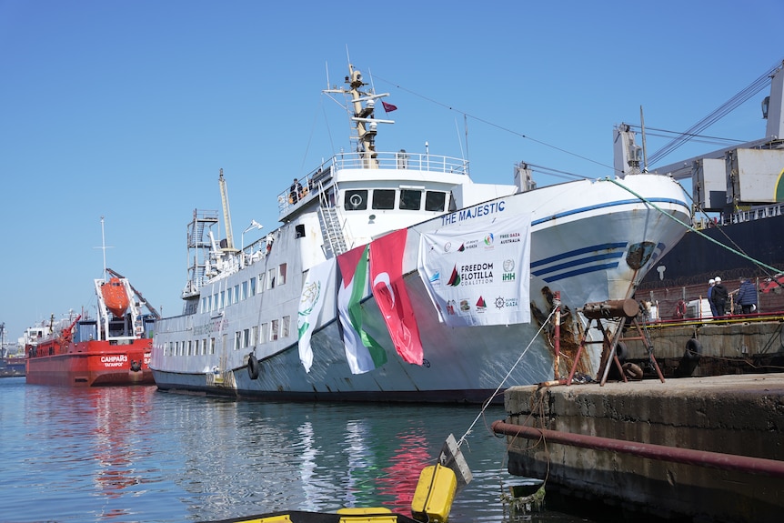 One of the FFC ships from up close. It's white and the Turkish and Palestinian flags hang off of it.