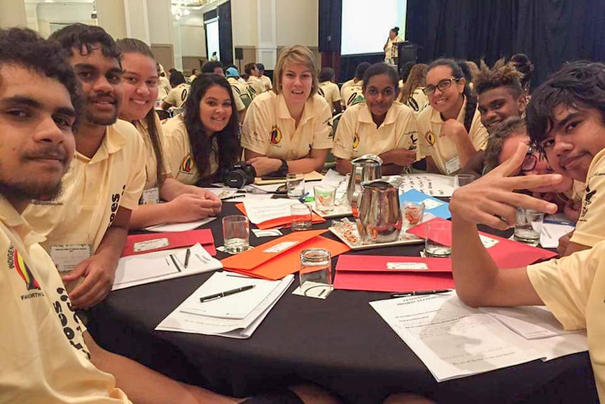 Babinda State School's Indigenous Leadership Team sits around a table with their teacher Rosie Burrows.