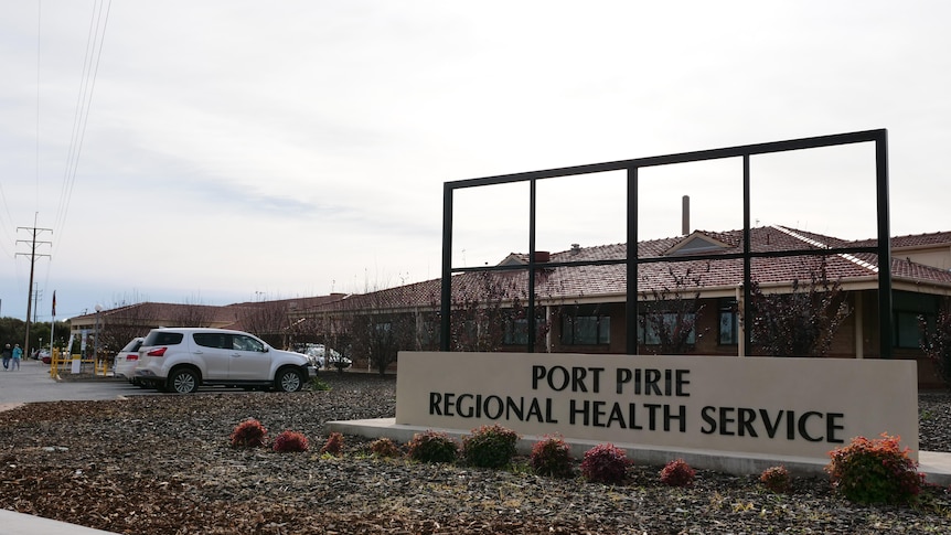 A large sign reading Port Pirie Regional Health Service outside a collection of buildings.