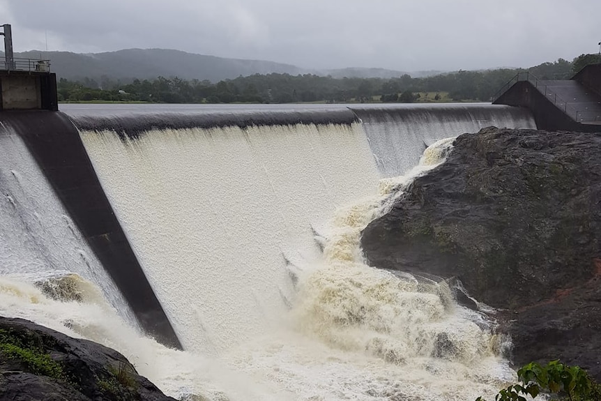 Water flows over the dam wall at Wappa Dam on the Sunshine Coast.