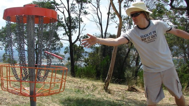 Frisbee golfer Richard Sampson throws a disc into the net