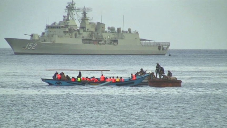 The Australian Navy investigate a boat carrying asylum seekers