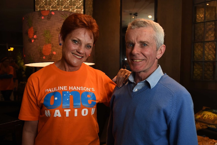 One Nation's Pauline Hanson poses for a photo with Malcolm Roberts, number two on her senate ticket.