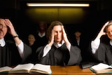 animation of people in black robes holding their heads