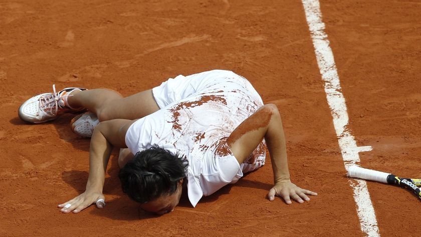 French kiss: Italy's Francesca Schiavone shares a moment with the Paris clay after beating Sam Stosur.