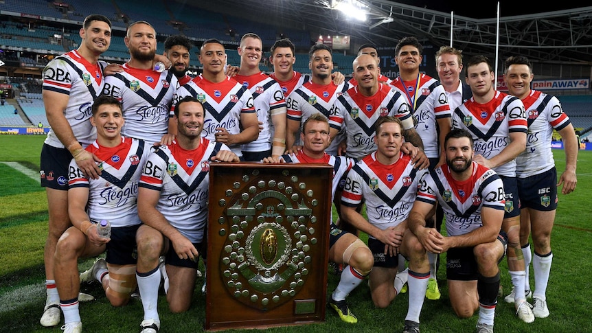 Roosters players pose with the JJ Giltinan Shield.