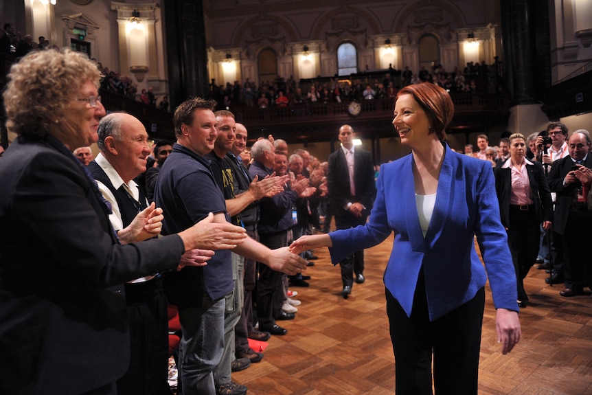 Warm welcome ... Julia Gillard shakes hands with delegates on her arrival at the conference.