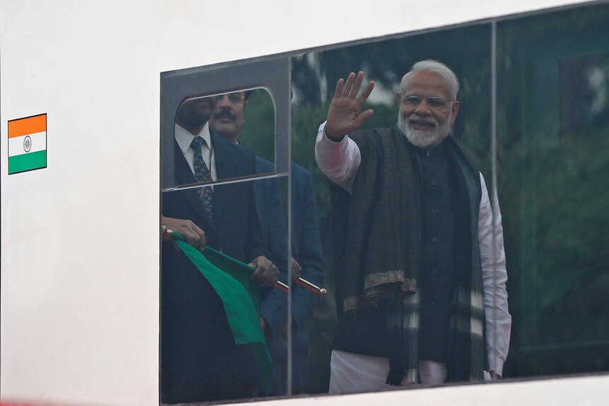 The Indian Prime Minister waves to the train as it leaves