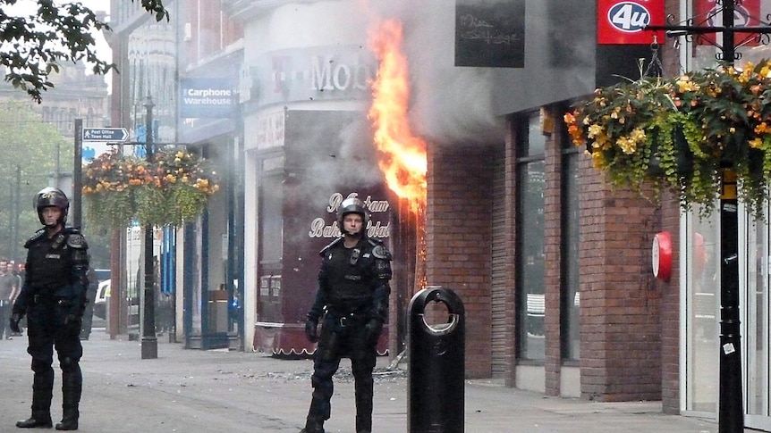 Rioters torch Manchester store following a fourth night of violence in Britain.