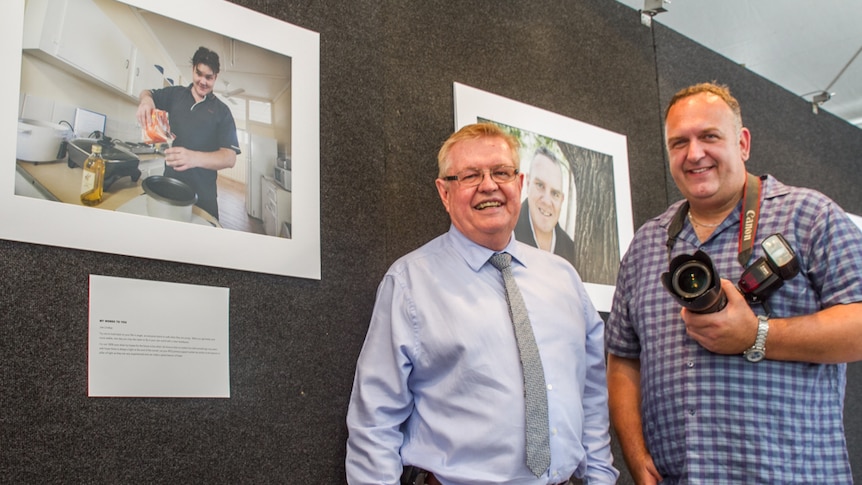 RFQ CEO Kingsley Bedwell with Brisbane photographer Andrew Leggett with his photos from Recovery in Focus.