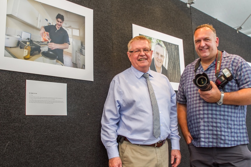 RFQ CEO Kingsley Bedwell with Brisbane photographer Andrew Leggett with his photos from Recovery in Focus.