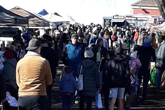 A large crowd of people at a market.