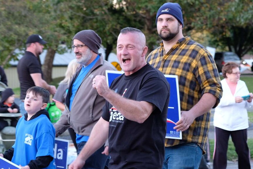 House candidate Richard Ojeda pumps his fist during a Halloween parade in West Virginia.