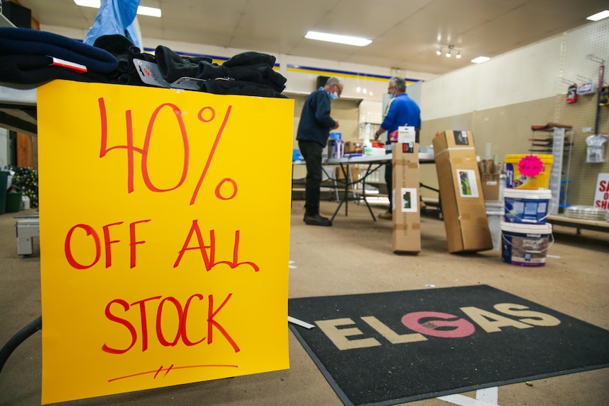A sign reading "40% off all stock" in a hardware store