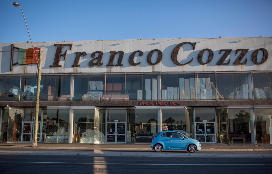 A car drives past Franco Cozzo furniture store.