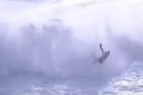 A jet ski crashes into the surf