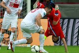 Tight tangle ... Poland's Marcin Wasilewski (L) challenges Russia's Andrei Arshavin (R) during their 1-1 draw.