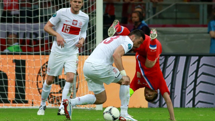 Marcin Wasilewski and Andrei Arshavin challenge during the Russia v Poland game at Euro 2012.
