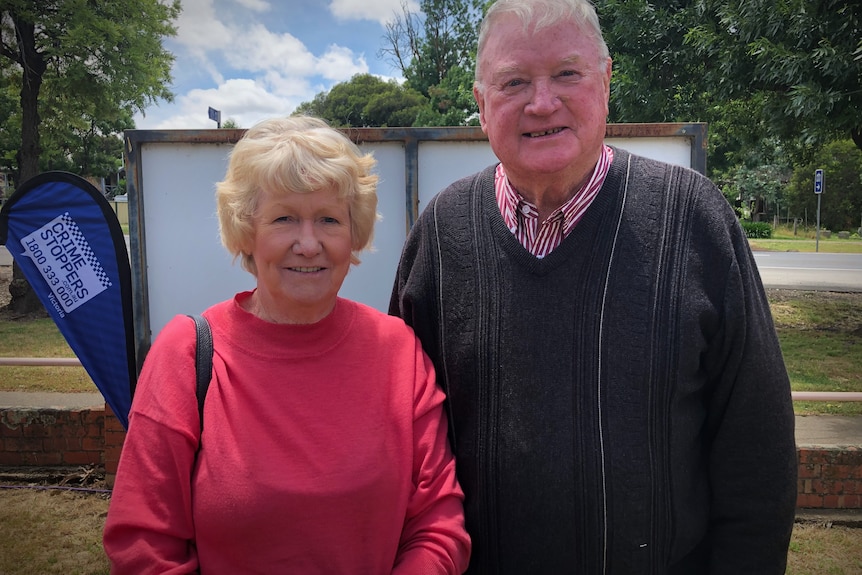 An old couple have their photo taken