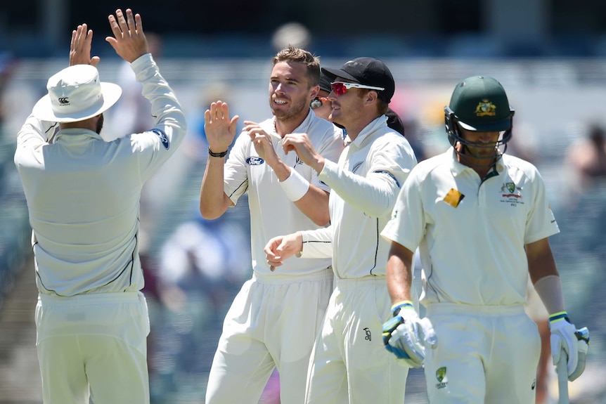 New Zealand's Tim Southee (c) celebrates dismissing Australian batsman Joe Burns for 0 at the WACA.