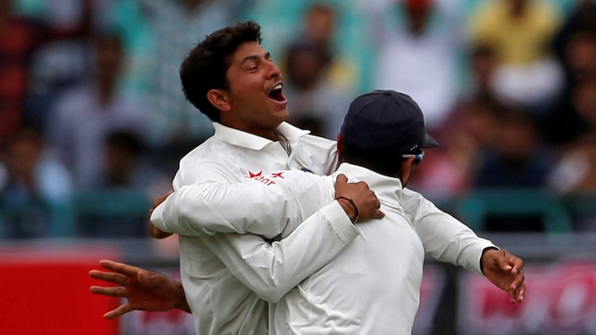 India's Kuldeep Yadav and Murali Vijay celebrate Peter Handscomb's wicket on day one in Dharamsala.
