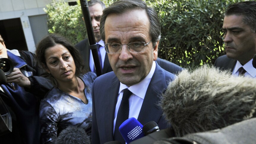 Leader of the Greek main opposition party, Antonis Samaras talks to reporters after his meeting with Greece's president