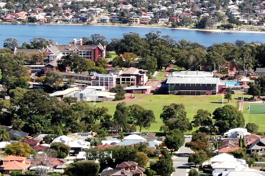 A drone aerial photo of a leafy suburb with spacious private school ground with ovals.