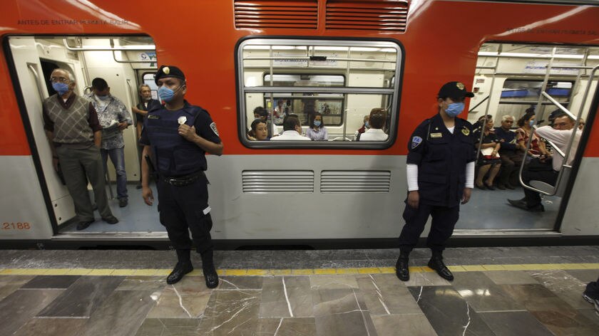 Policeman standing guard at a metro in Mexico