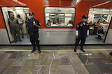 Policeman standing guard at a metro in Mexico
