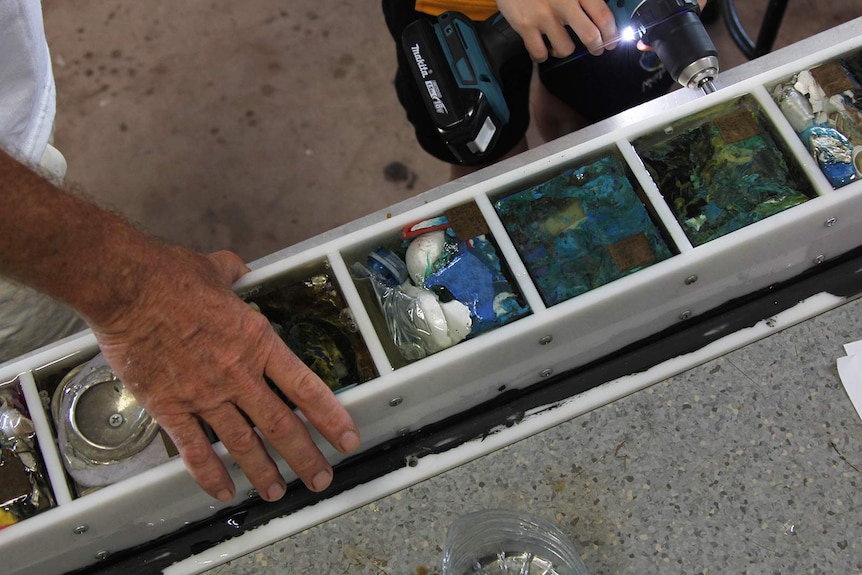 An aerial view of some cubes of ocean waste as the container is drilled open.