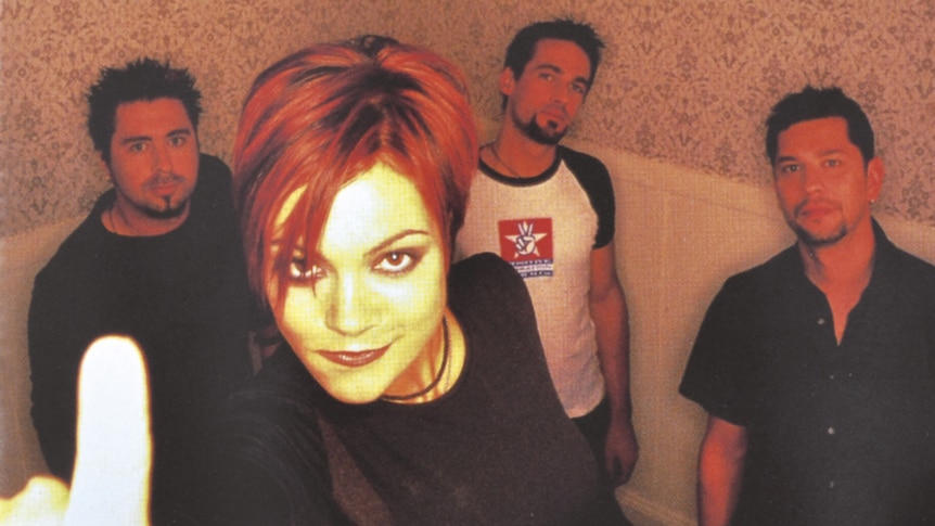 Adelaide rock band The Superjesus stare into the camera. Frontwoman Sarah McLeod holds up one finger