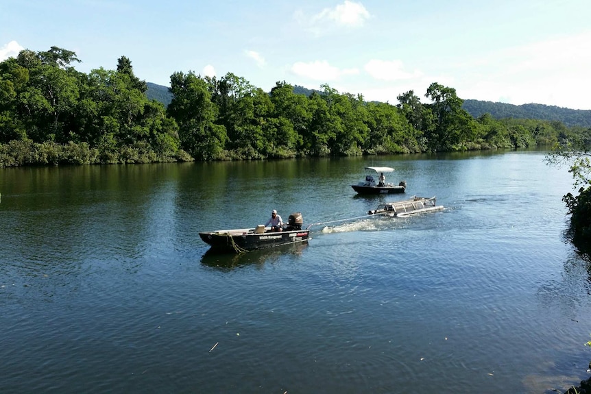 Wildlife officers remove a floating trap