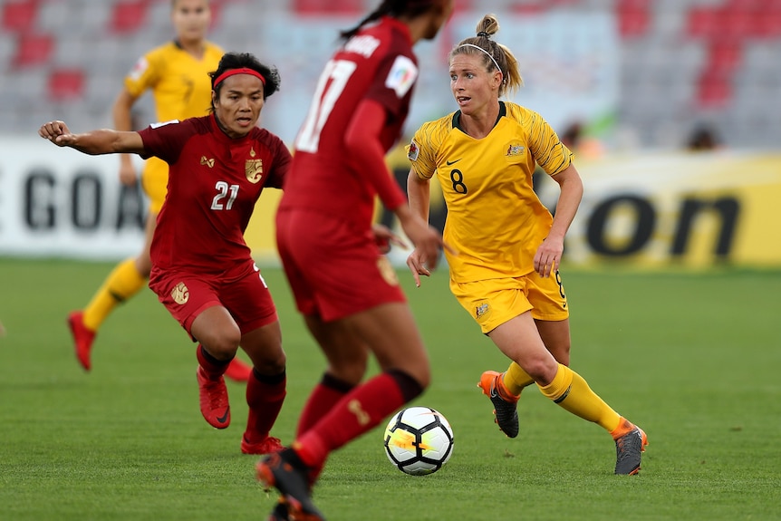 Players of Thailand and Australia compete for the ball at the 2018 Asian Cup