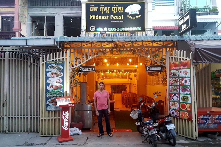 Abdullah Zalghani stands outside his restaurant in Cambodia