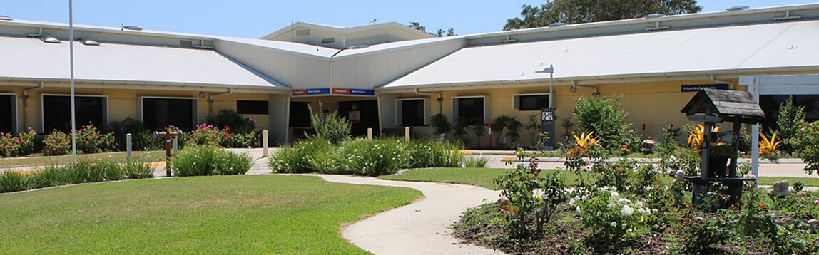 The front of a single-storey hospital with a lawn out the front
