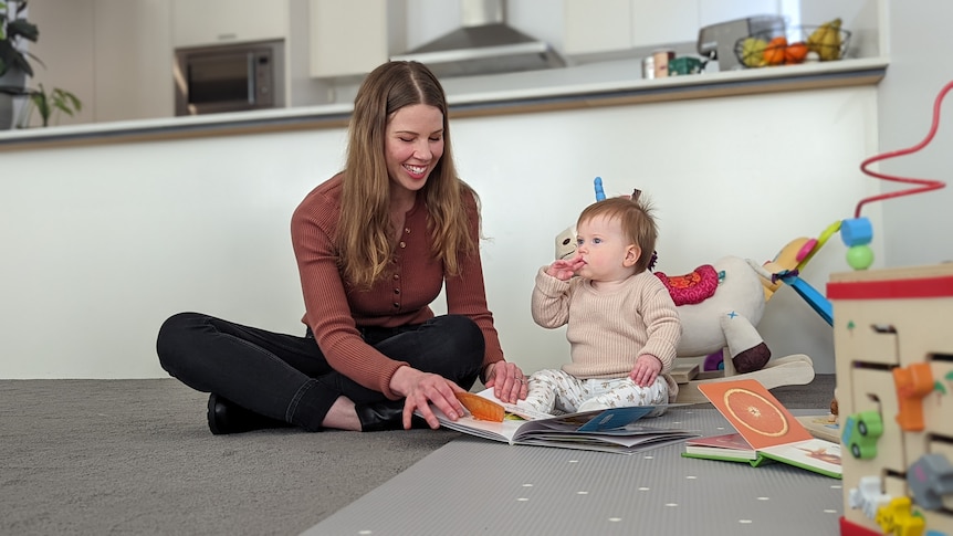 A mother playing with a baby