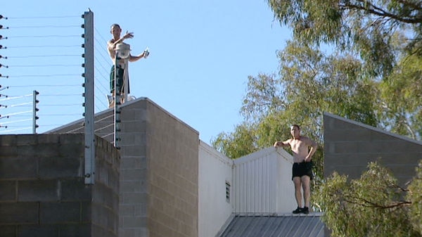 Two inmates staged a protest on the roof of the Belconnen Remand Centre about overcrowding on Friday.