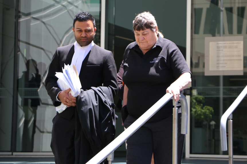 Perth mother Miriam Dow walks out of the District Court with her lawyer Shash Nigam.