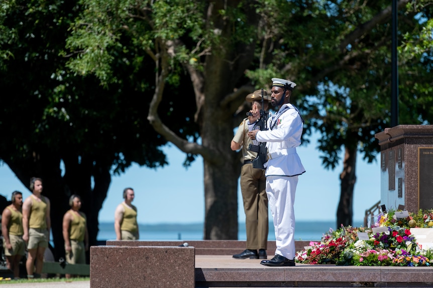 defence personnel standing at a cenotaph in darwin