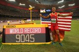 American Ashton Eaton poses after setting a new decathlon world record in Beijing.