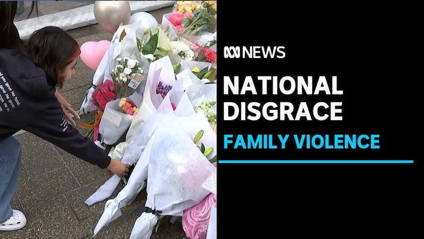 National Disgrace, Family Violence: A girl lays a bunch of flowers on a floral memorial.