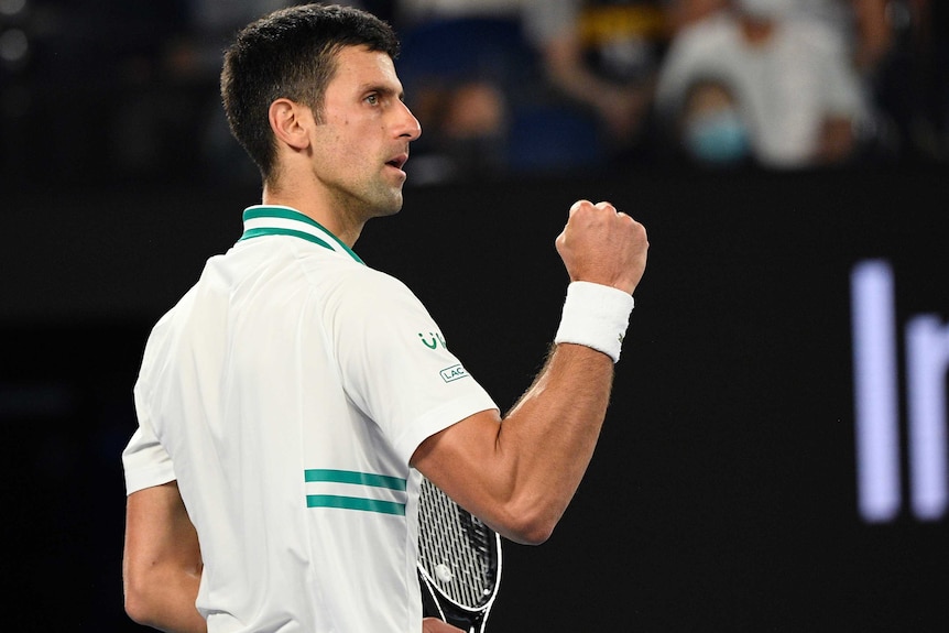 Tennis player reacts after winning a set.