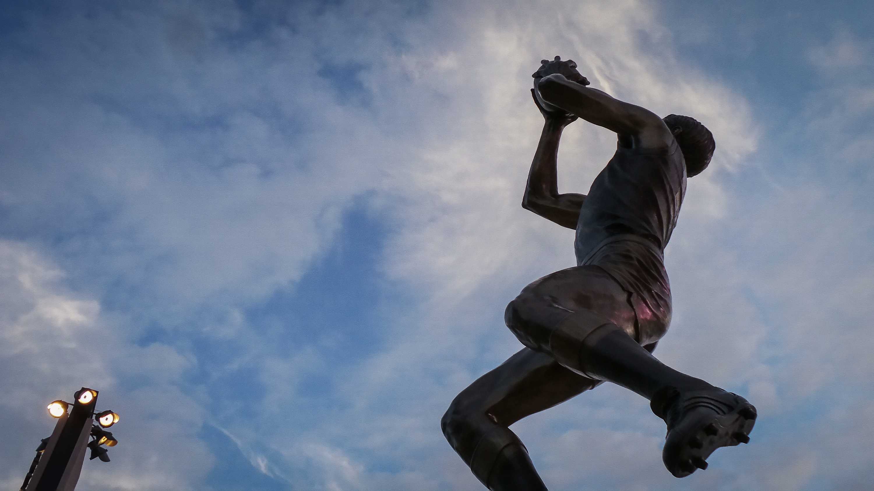 Bronze statue of footballer Barrie Robran in a classic "overhead mark" pose, outside the new Adelaide Oval