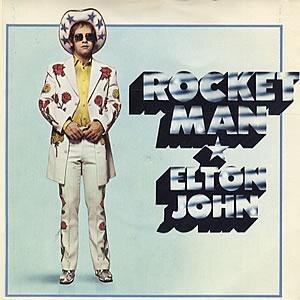 Elton John poses in a cowboy suit on the front cover of the single for Rocket Man.